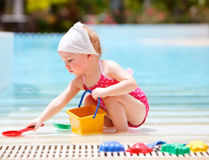 toddler playing by pool